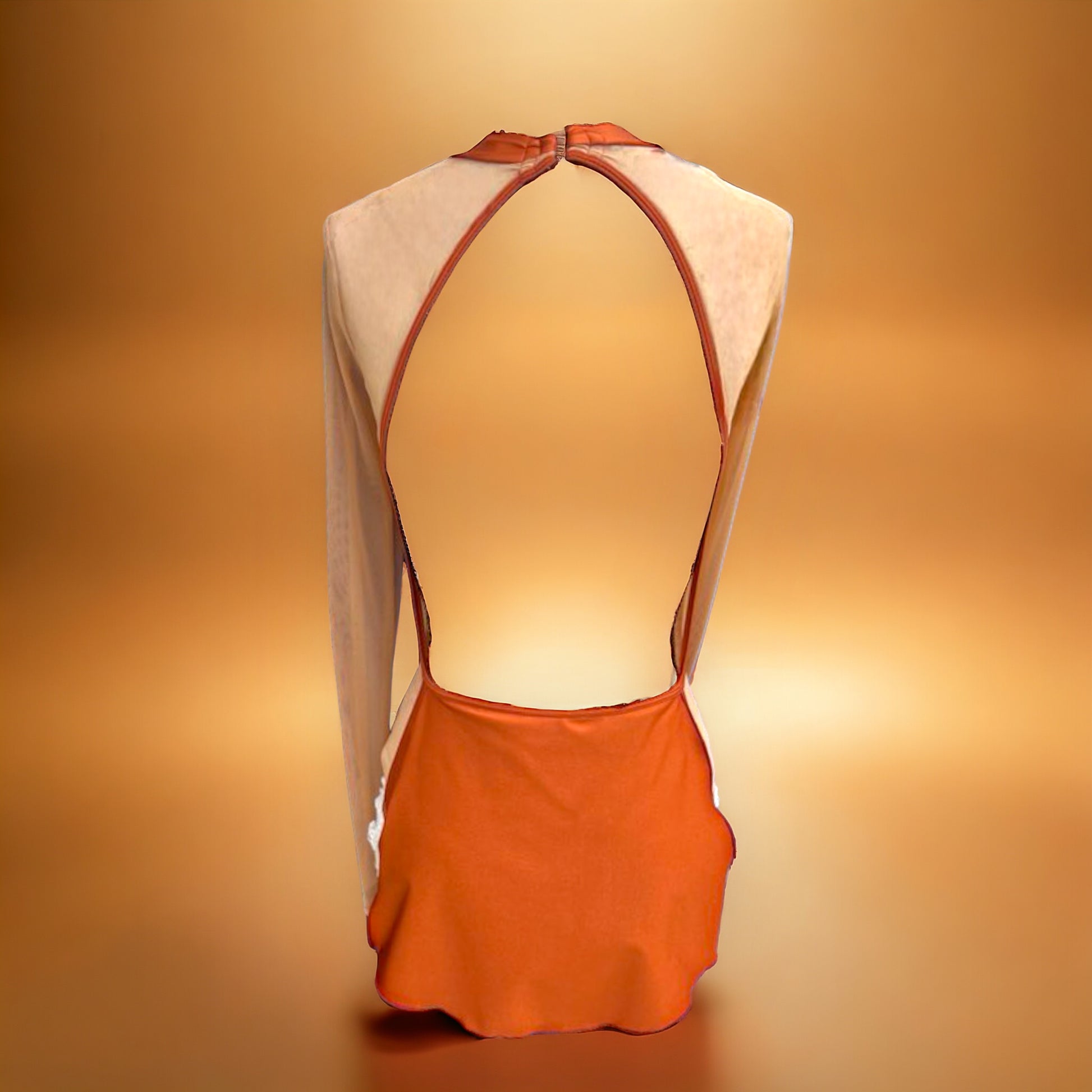 Introducing the Faith Costume Base. Designed with a high neck, long sleeves with a cuff, and a short skirt with high slits, this piece exudes elegance and luxury. Enhance your showstopping look with its unique shark bite and open back design. Versatile and sophisticated, this is a must-have for any costume collection.