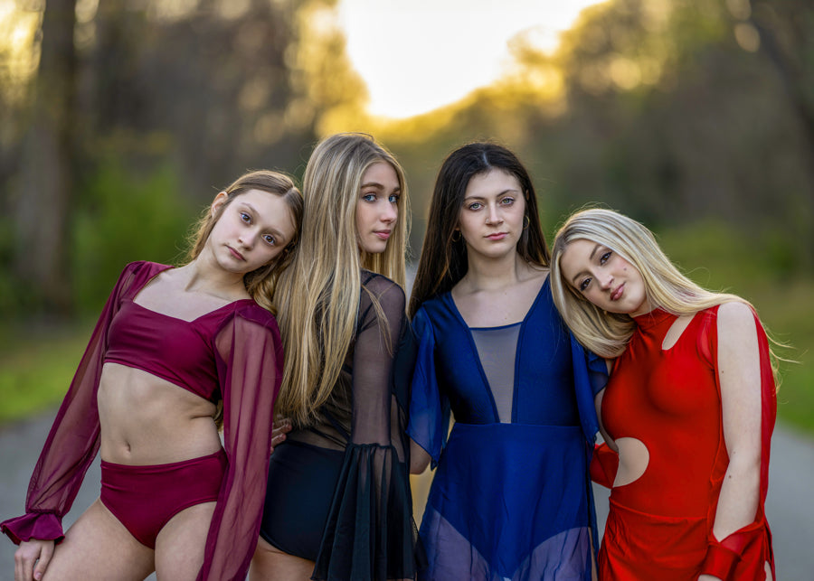 Transform your stage presence with the bell sleeves, curved bodice, and mesh cutouts of The Allonge leotard. Whether it's a solo or group performance, this design exudes flow, dramatic grace, and a bold statement for any dance group, team, or dancer. 