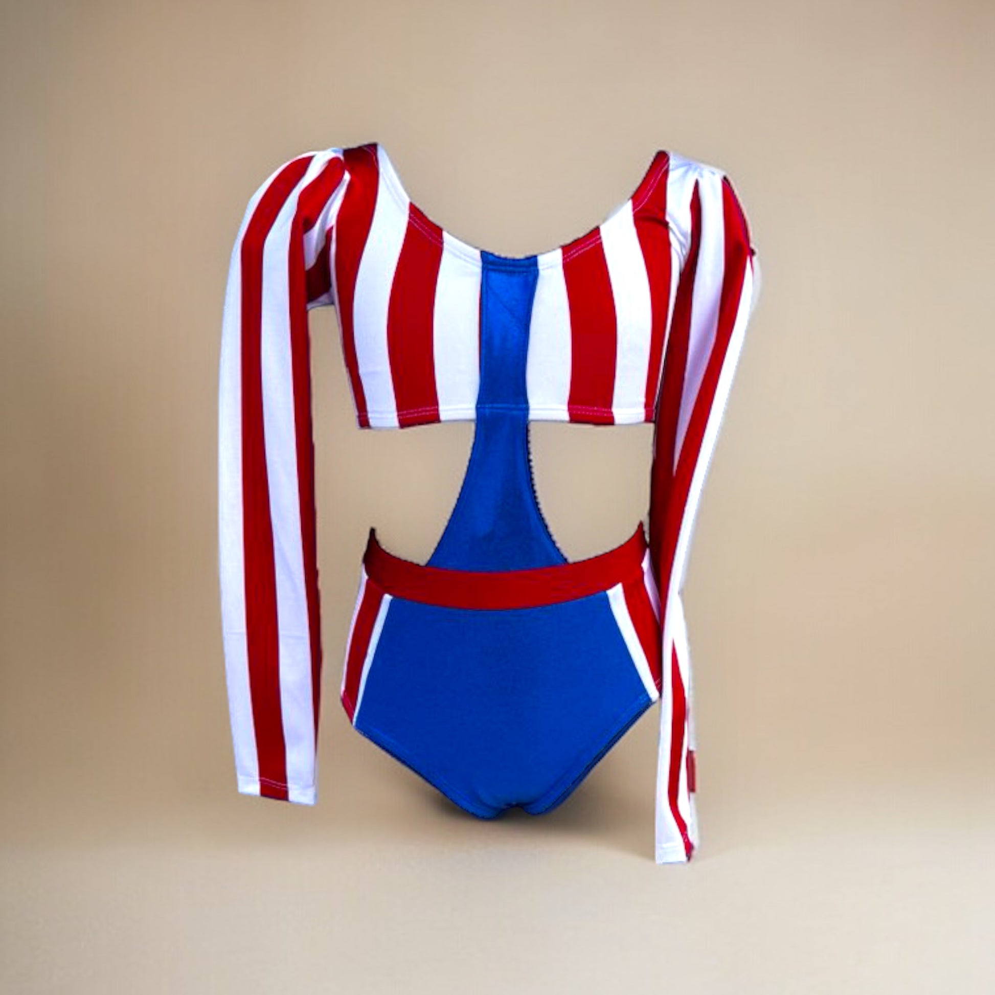 Get ready to rock the stage with our bandstand-inspired leotard! With metallic blue, white, and red stripes, puffed shoulders, and a high-waisted faux two-piece design, this show-stopping ensemble will make every performance a hit. Unleash your inner diva and dance with attitude in this unstoppable leotard by Opra Dancewear.