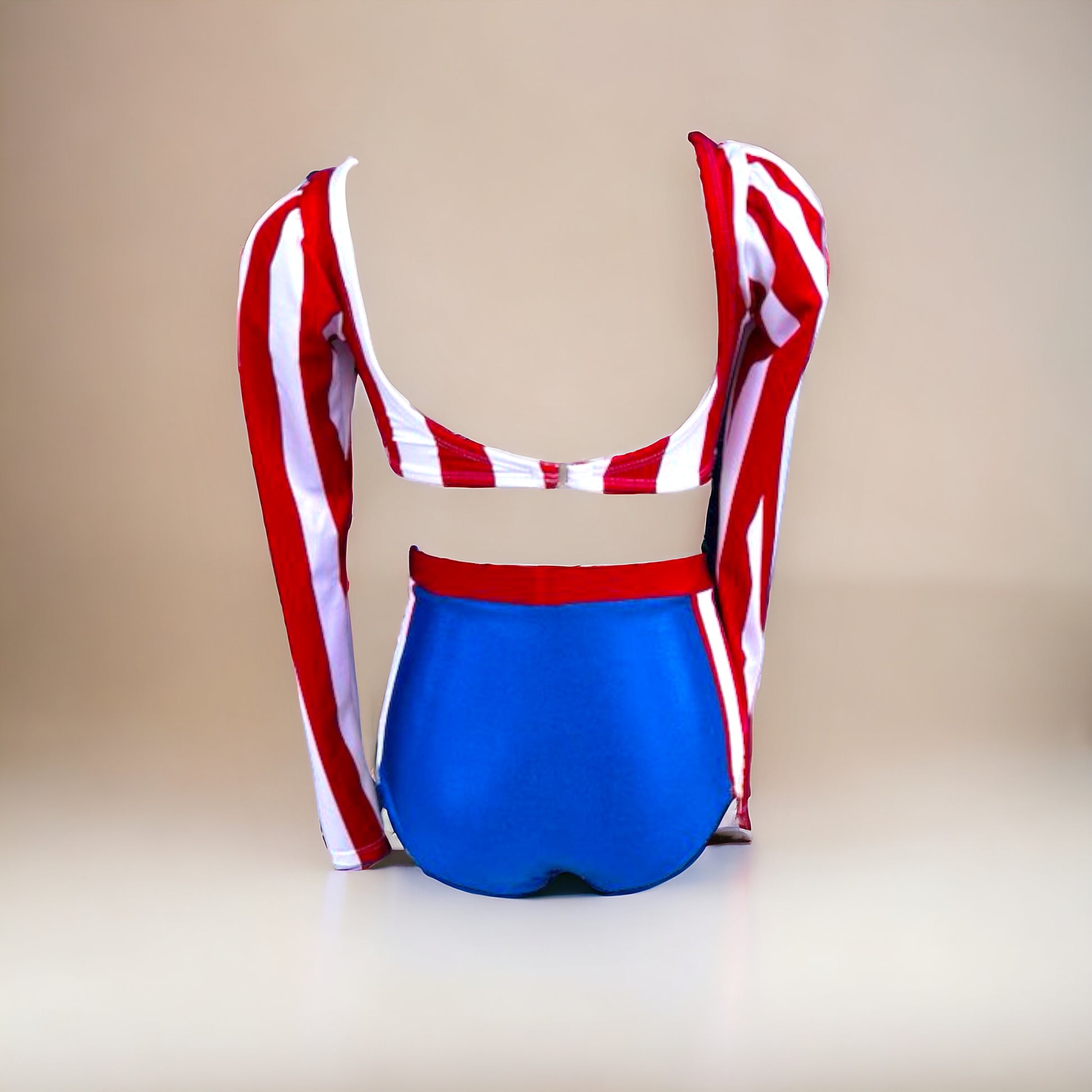 Get ready to rock the stage with our bandstand-inspired leotard! With metallic blue, white, and red stripes, puffed shoulders, and a high-waisted faux two-piece design, this show-stopping ensemble will make every performance a hit. Unleash your inner diva and dance with attitude in this unstoppable leotard by Opra Dancewear.