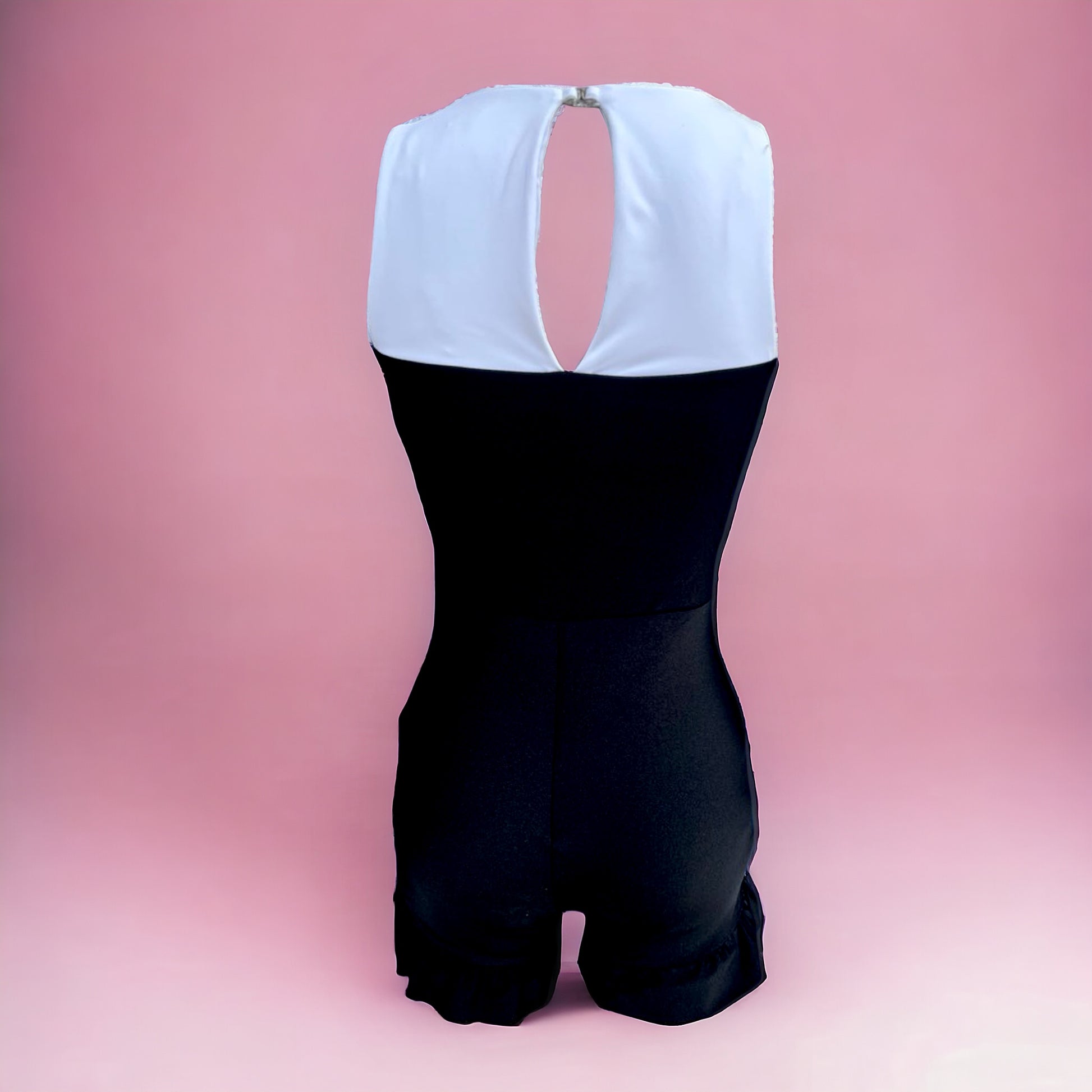Made to look like a bustier over a white tank, queue Britney's "Toxic", this biker has support, coverage, and ruffles all in one. Leave it as is for a Risky Business feel or add some stones along all the strapwork to really make a standout appearance. Only a few left in this. act fast!